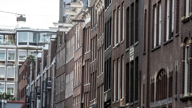 A row of traditional residential building facades in central Amsterdam, Netherlands, on Friday, Sept. 2, 2022. While the Dutch have long feared that climate change would see their homes engulfed by rising sea levels, Europe's record drought is causing groundwater levels to plunge, exposing wooden foundations.