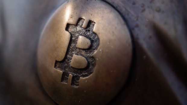 A Bitcoin logo on the sculpture representing Satoshi Nakamoto, the pseudonymous creator of Bitcoin, in the grounds of Graphisoft Park in Budapest, Hungary, on Friday, Feb. 18, 2022. Bitcoin is testing $40,000, a key psychological level, as the U.S. plan talks with Russia about military intelligence that suggests an imminent Ukraine invasion, which it denies. Photographer: Akos Stiller/Bloomberg