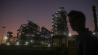 A pedestrian walks past an oil refinery, operated by Bharat Petroleum Corp. Ltd., in Mumbai, India, on Saturday, Dec. 10, 2022. A senior official at India's oil ministry told reporters this month India has been buying oil from about 30 countries, and will continue to buy from anywhere including Russia beyond January. Photographer: Dhiraj Singh/Bloomberg