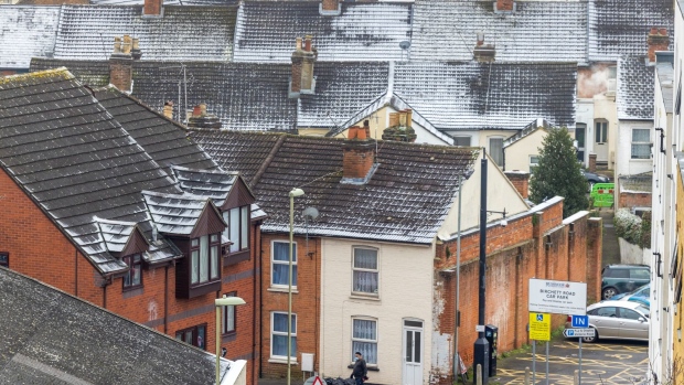 Snow-covered roofs on terraced houses in Aldershot, UK, Monday, Dec. 12, 2022. UK power prices for Monday jumped to record levels as freezing temperatures are set to cause a surge in demand, just as a drop in wind generation causes a supply crunch.