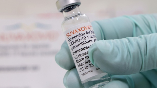 A healthcare worker holds an empty vial of the Novavax Inc. Nuvaxovid Covid-19 vaccine at the Tegel Vaccine Center in Berlin, Germany, on Monday, March 7, 2022. There are hopes that Nuvaxovid could boost vaccination efforts that have flagged among the hesitant, according to Novavax, as the jab uses a technology which some people might find more appealing.