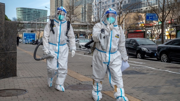 Workers wearing protective gear in Beijing, China, on Thursday, Dec. 15, 2022. China's economic activity worsened in November before the government abruptly dropped its Covid Zero policy, with more disruption to growth likely as infections surge. Bloomberg