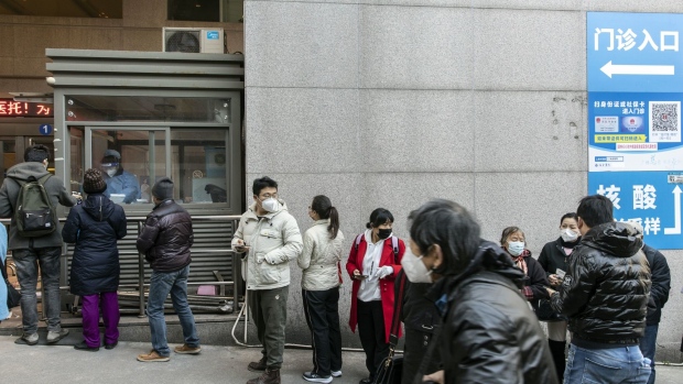 People queue for Covid rapid antigen tests before entering a hospital in Shanghai, China, on Thursday, Dec. 15, 2022. As Covid spreads rapidly across China, elderly care homes are barricading their doors in an attempt to save their vulnerable patients. Photographer: Qilai Shen/Bloomberg