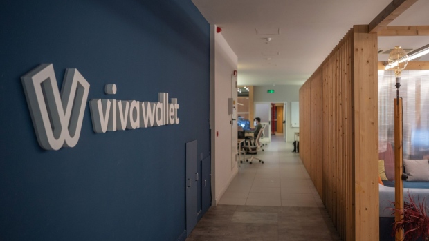 The Viva Wallet logo on a wall in the company offices in Athens, Greece, on Tuesday, April 5, 2022. JPMorgan Chase & Co. is planning to use its recently acquired stake in Greek payments firm Viva Wallet to support lending to small businesses right across European markets, an ambition that would supply a rare cohesion to the continent’s fragmented banking markets. Photographer: Nick Paleologos/Bloomberg
