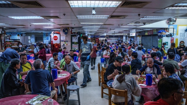 People dine in a food court in the Causeway Bay district during its reopening in Hong Kong, China, on Saturday, May 7, 2022. Hong Kong is accelerating its reopening plans as Covid cases drop, easing mask-wearing rules and allowing more leisure venues to reopen, despite continued circulation of the pathogen that has led most rival financial hubs to live with the virus.