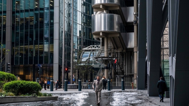 A city worker walks along an ice-covered footpath outside The Leadenhall Building, also known as The Cheesegrater, during a quiet lunchtime due to train strikes in the City of London, UK, on Tuesday, Dec. 13, 2022. Rail workers have begun a series of strikes designed to cripple Britain's transport system over the Christmas period, leading the transport secretary to claim that public opinion is turning against the unions.
