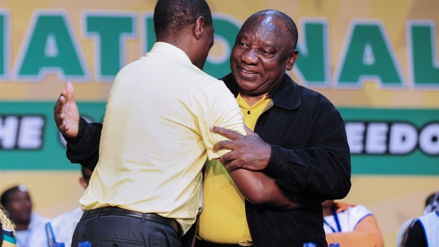 Paul Mashatile and Cyril Ramaphosa embrace following the results on Dec. 19.