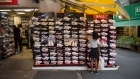 A shopper looks at Nike sneakers for sale at the Ameyoko shopping street in Tokyo, Japan, on Sunday, Sept. 5, 2021. Prime Minister Yoshihide Suga's strategy of light virus restrictions for prolonged periods of time has stretched the patience of consumers and business owners while having limited impact on infection rates.