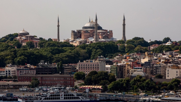 A ferry boat sits docked on the Bosporus beneath the The Hagia Sophia mosque on the city skyline in the Sultanahmet district of Istanbul, Turkey, on Tuesday, July 21, 2020. When President Recep Tayyip Erdogan reopens Istanbul’s Hagia Sophia for prayers next week, it will be the crowning symbol of his mission to reassert Turkey’s role as a Muslim power on the global stage. Photographer: Kerem Uzel/Bloomberg