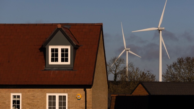 Wind turbines near residential houses near Burton Latimer, UK, on Wednesday, Dec. 14, 2022. UK power prices for Monday jumped to record levels as freezing temperatures are set to cause a surge in demand, just as a drop in wind generation causes a supply crunch. Photographer: Chris Ratcliffe/Bloomberg