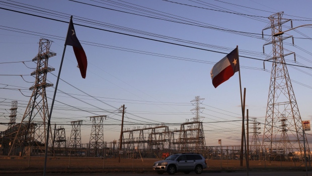 HOUSTON, TEXAS - FEBRUARY 21: Texas flags fly near an electrical substation on February 21, 2021 in Houston, Texas. Millions of Texans lost their power when winter storm Uri hit the state and knocked out coal, natural gas and nuclear plants that were unprepared for the freezing temperatures brought on by the storm. Wind turbines that provide an estimated 24 percent of energy to the state became inoperable when they froze. (Photo by Justin Sullivan/Getty Images)