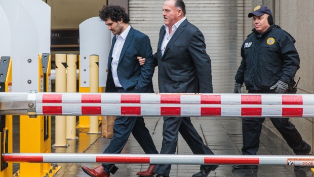 Sam Bankman-Fried, co-founder of FTX Cryptocurrency Derivatives Exchange, left, departs from court in New York, US, on Thursday, Dec. 22, 2022. Bankman-Fried was released on a $250 million bail package after making his first US court appearance to face fraud charges over the collapse of FTX, the cryptocurrency exchange he co-founded.