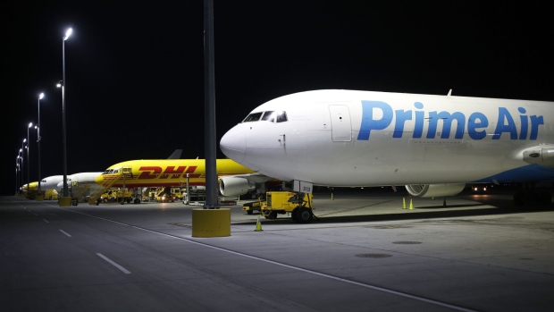 An Amazon.com Inc. Prime Air cargo jet sits parked at the DHL Worldwide Express hub of Cincinnati/Northern Kentucky International Airport in Hebron, Kentucky, U.S., on Wednesday, Aug. 16, 2017. The Deutsche Post AG, parent company to Worldwide Express, second-quarter operating profit jumped 12 percent as the German mail operator handled more express deliveries and won more business at its logistics unit.