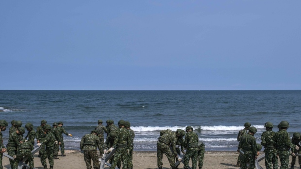 Soldiers set up barricades on a beach during a military exercise in Miaoli, Taiwan, on Tuesday, July 26, 2022. The dispute over Taiwan's sovereignty is the main issue that risks one day leading to war between the US and China, with calls growing among American politicians for a commitment to get involved if Beijing invades the island. Photographer: Lam Yik Fei/Bloomberg