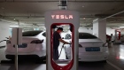 A driver charges a Tesla Inc. Model 3 electric vehicle (EV) at a Tesla Supercharger station in Suwon, South Korea, on Sunday, Aug. 7, 2022. Throughout the pandemic, individual South Koreans thronged into Tesla stock, increasing their combined holdings more than a hundredfold, to exceed $15 billion. Photographer: SeongJoon Cho/Bloomberg