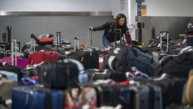 A traveler looks for their luggage in the Southwest Airlines baggage claim at Oakland International Airport in Oakland, California.