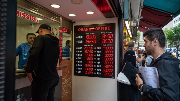 An electronic board displays exchange rates information at a currency exchange bureau in the Eminonu district of Istanbul, Turkey, on Tuesday, Sept. 20, 2022. Key Turkish banks are buying back shares after stocks reversed an unprecedented rally last week, providing relief for brokerages hit by the rout. Photographer: Erhan Demirtas/Bloomberg
