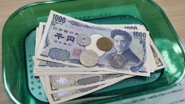 Japanese yen coins and banknotes on a tray arranged at a branch of Resona Bank Ltd. in Tokyo, Japan, on Tuesday, Aug. 9, 2022. Dollar-yen, which soared 38% from a March 2020 trough to mid-July this year, is in retreat. Photographer: Kiyoshi Ota/Bloomberg