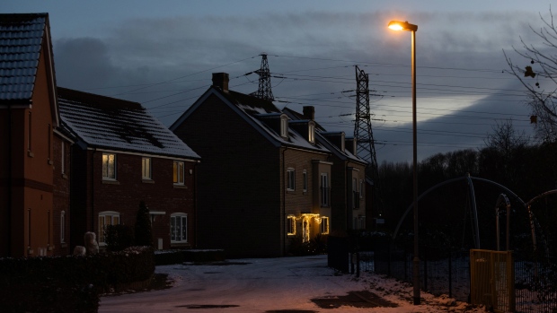 A lit street lamp on a residential street in St Neots, UK, on Wednesday, Dec. 14, 2022. UK power prices for Monday jumped to record levels as freezing temperatures are set to cause a surge in demand, just as a drop in wind generation causes a supply crunch. Photographer: Chris Ratcliffe/Bloomberg
