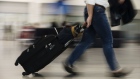 A traveler pulls luggage through Toronto Pearson International Airport (YYZ) in Toronto, Ontario, Canada, on Monday, July 22, 2019. In 2018, 49.5 million passengers traveled through Pearson on 473,000 flights.