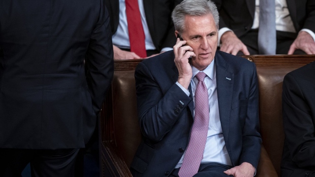 Representative Kevin McCarthy, a Republican from California, speaks on a phone during a meeting of the 118th Congress in the House Chamber at the US Capitol in Washington, DC, US, on Friday, Jan. 6, 2023. The emerging deal McCarthy is discussing to make him speaker of the House would propose a roughly $75 billion cut in defense spending at a time when the US is intent on backing Ukraine against the Russian invasion and grows more wary of China's stepped up aggression toward Taiwan.