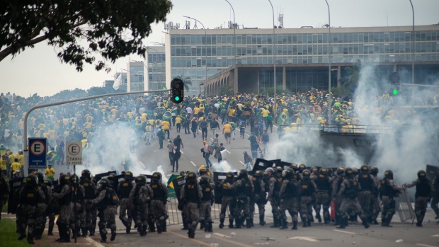 Bolsonaro supporters clash with law enforcement officers outside Congress in Brasília. Photographer: Matheus Alves./picture alliance/Getty Images