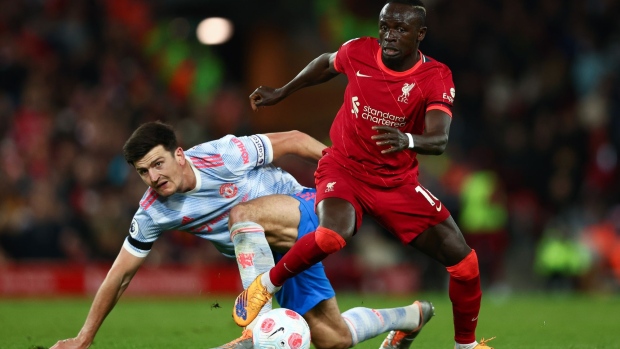 LIVERPOOL, ENGLAND - APRIL 19: Harry Maguire of Manchester United looks on as Sadio Mane of Liverpool runs with the ball during the Premier League match between Liverpool and Manchester United at Anfield on April 19, 2022 in Liverpool, England. (Photo by Clive Brunskill/Getty Images)