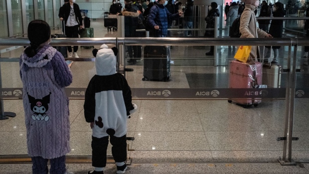 Two children wait for a relative in the arrival hall for international flights at Beijing Capital Airport on Jan. 8.