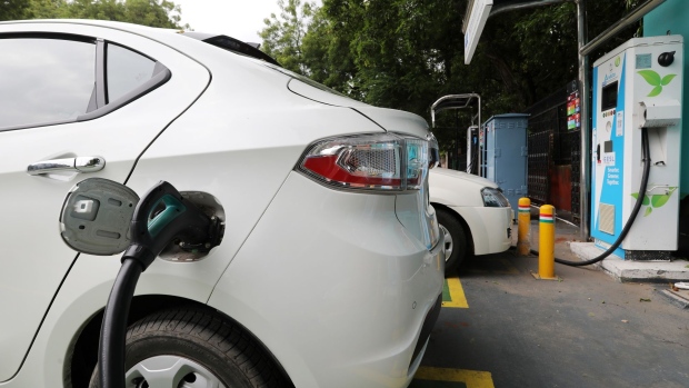 An electric vehicle (EV) is connected at a charging station operated by Energy Efficiency Services Ltd. (EESL), a joint venture between four state-run power companies -- NTPC Ltd., Power Grid Corp., Power Finance Corp. and REC Ltd., in New Delhi, India, on Tuesday, Aug. 25, 2020. India aspires to rapidly scale-up local manufacturing and adoption of electric vehicles to raise its competitiveness in the global auto-manufacturing industry as well as to tackle its high fuel import bill and urban pollution. Photographer T. Narayan/Bloomberg