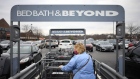 A customer wearing a protective mask retrieves a shopping cart outside a Bed Bath & Beyond store in Louisville, Kentucky, U.S., on Saturday, Jan. 2, 2021. Bed Bath & Beyond Inc. is scheduled to release earnings figures on January 7.