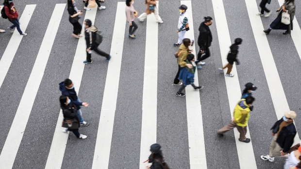 Pedestrians cross a road in the Xinyi district in Taipei, Taiwan, on Wednesday, Nov. 24, 2021. Taiwan, home to several major producers of leading-edge semiconductors, has been among the biggest beneficiaries of a global rebound in trade as the Covid-19 pandemic eases. Photographer: I-Hwa Cheng/Bloomberg