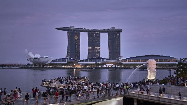 Crowds by the Merlion and Marina Bay Sands in Singapore, on Saturday, July 9, 2022.  Photographer: Lauryn Ishak/Bloomberg