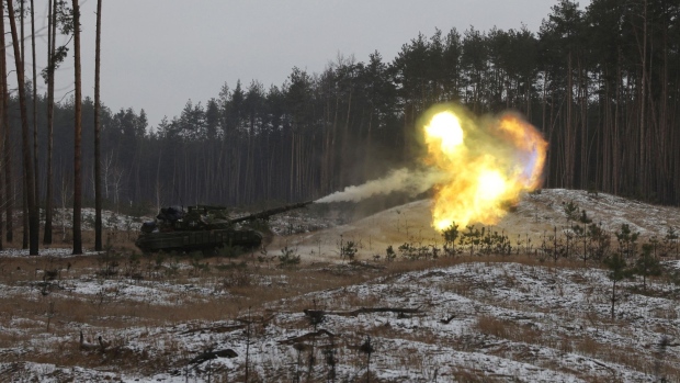 A Ukrainian tank fires at Russian positions near Kreminna, Lugansk region, Ukraine, on Jan. 12. Photographer: Anatolii Stepanov/AFP/Getty Images