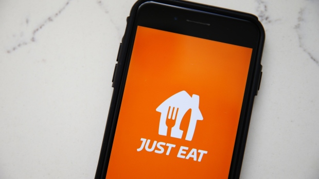 The Just Eat Takeaway.com NV logo is displayed on a smartphone in this arranged photograph in London, U.K., on Tuesday, Aug. 11, 2020. Just Eat are due to report earnings on Aug. 12. Photographer: Hollie Adams/Bloomberg