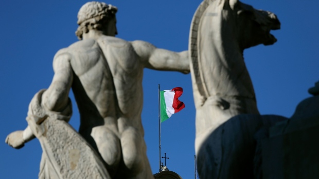 The Italian national flag, center, flies on top of The Quirinale Palace, the presidential palace, in Rome, Italy, on Saturday, Jan. 29, 2022. Italy's papal-style vote for a new president each seven years is the culmination of Rome’s political intrigues and power games. Photographer: Alessia Pierdomenico/Bloomberg