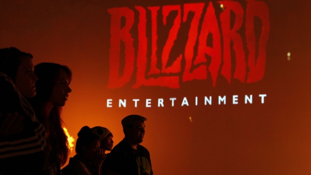 Attendees stand in front of the logo for Blizzard Entertainment Inc., a unit of Activision Blizzard Inc., as they watch a trailer for a video game during the E3 Electronic Entertainment Expo in Los Angeles.