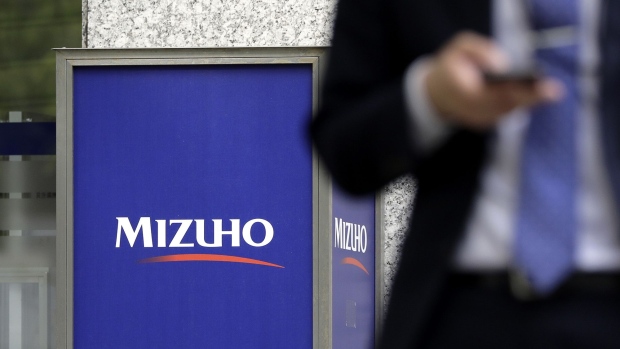 Signage for automated teller machines (ATM) at a Mizuho Bank Ltd., a unit of Mizuho Financial Group Inc. (MHFG), is displayed outside a branch in Tokyo.