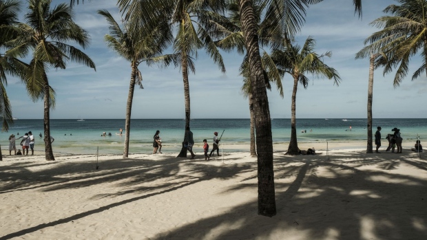 Visitors frolic on a beach in Boracay, the Philippines, in 2022. 