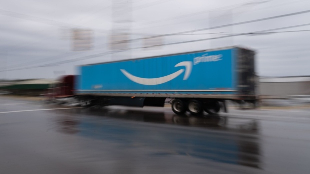 A semi truck with the Amazon.com Inc. Prime logo travels along a road outside the company's BHM1 Fulfillment Center in Bessemer, Alabama, U.S., on Saturday, Feb. 6, 2021. The campaign in Bessemer to unionize Amazon workers has drawn national attention and is widely considered a once-in-a-generation opportunity to breach the defenses of the world’s largest online retailer, which has managed to keep unions out of its U.S. operations for a quarter-century. Photographer: Elijah Nouvelage/Bloomberg