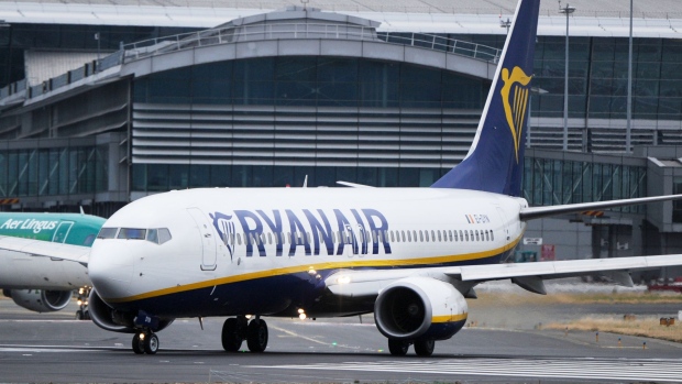 A passenger aircraft operated by Ryanair Holdings Plc taxis on the tarmac at Dublin Airport in Dublin, Ireland, on Thursday, July 12, 2018. Ryanair grounded dozens of flights Thursday as pilots in its Irish home market walked out after failing to agree new contracts as part of a move toward unionization at the discount giant. Photographer: Aidan Crawley/Bloomberg