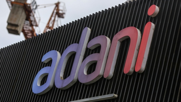 Signage of Adani Group at company's residential building under construction in Mumbai, India, on Tuesday, Sep. 6, 2022. Adani Group, indirectly acquired a 29.2% stake in New Delhi Television Ltd., or NDTV, and offered to buy another 26% from the open market for a combined 6.07 billion rupees ($76 million) in August 2022. Photographer: Dhiraj Singh/Bloomberg