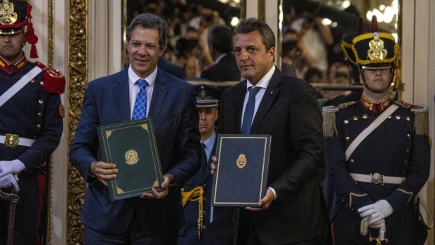 Brazil’s Finance Minister Fernando Haddad, left, and Argentina’s Economy Minister Sergio Massa hold signed documents during a news conference at Casa Rosada in Buenos Aires on Jan. 23