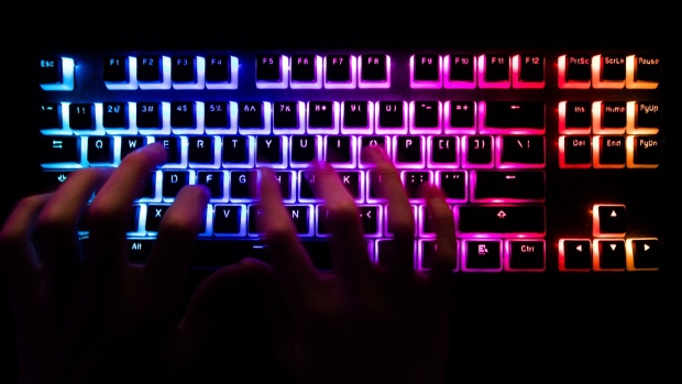A person typing at a backlit computer keyboard arranged in Danbury, U.K., on Tuesday, Dec. 29, 2020. In the spring, hackers managed to insert malicious code into a software product from an IT provider called SolarWinds Corp., whose client list includes 300,000 institutions. Photographer: Chris Ratcliffe/Bloomberg