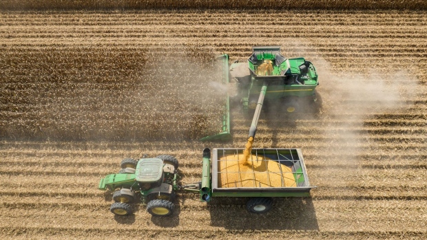 A combine harvester transfers corn to a grain cart in Leland, Mississippi. Photographer: Rory Doyle/Bloomberg