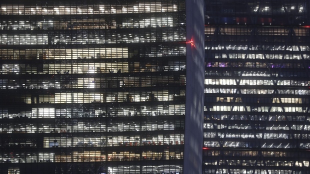 Electrical lights illuminate offices inside a commercial building at night in London, U.K., on Thursday, Nov. 17, 2016. More than 1,900 firms are likely to review their office-space requirements in London following the U.K.’s decision to leave the European Union. Photographer: Simon Dawson/Bloomberg