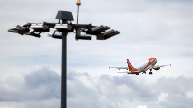 A passenger aircraft, operated by EasyJet Plc, taking off at London Luton Airport in Luton, U.K., on Monday, July 25, 2022. EasyJet are due to report their latest earnings on Tuesday. Photographer: Chris Ratcliffe/Bloomberg