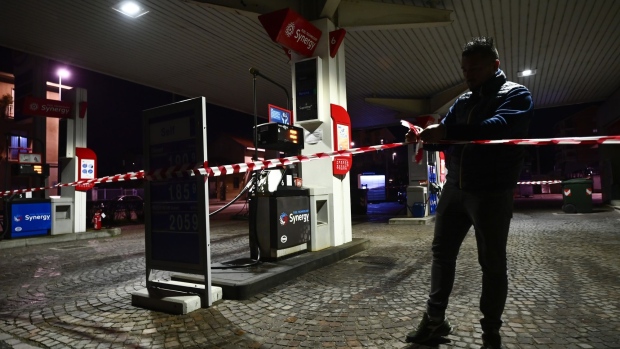 A worker closes a petrol station during the strike in Turin. Photographer: Stefano Guidi/Getty Images