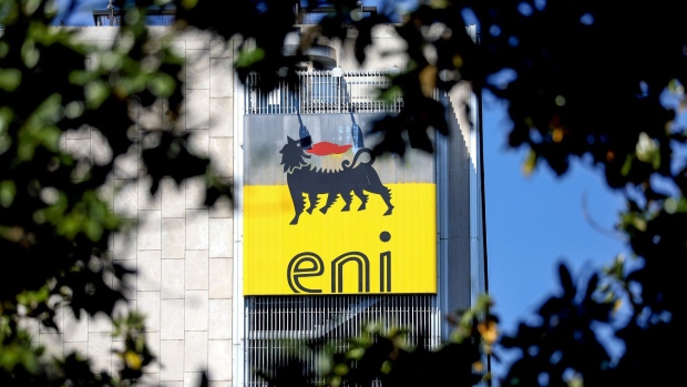 The ENI SpA logo sits on the company's headquarters office building seen through trees in Rome, Italy, on Friday, April 24, 2020. Eni SpA reported a 94% drop in first-quarter profit and cut its production forecast for the year as demand is crushed by the coronavirus pandemic.