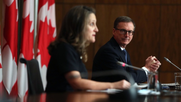 Tiff Macklem, governor of the Bank of Canada, listens during a news conference with Chrystia Freeland, Canada's deputy prime minister and finance minister, in Ottawa, Ontario, Canada, on Monday, Dec. 13, 2021. The Bank of Canada will maintain its 2% inflation target for the next five years, but has formally been given license to moderately overshoot it to "support maximum sustainable employment."