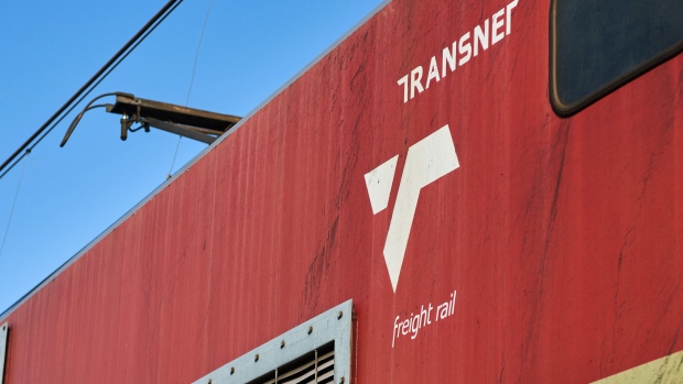 A logo on the exterior of a Transnet SOC Ltd. freight train transporting coal from the Mafube open-cast coal mine, operated by Exxaro Resources Ltd. and Thungela Resources Ltd., towards Richard's Bay coal terminal, in Mpumalanga, South Africa on Thursday, Sept. 29, 2022. South Africa relies on coal to generate more than 80% of its electricity, and has been subjected to intermittent outages since 2008 because state utility Eskom Holdings SOC Ltd. can't meet demand from its old and poorly maintained plants. Photographer: Waldo Swiegers/Bloomberg